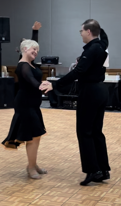 Couple dancing the Bolero in an indoor ballroom