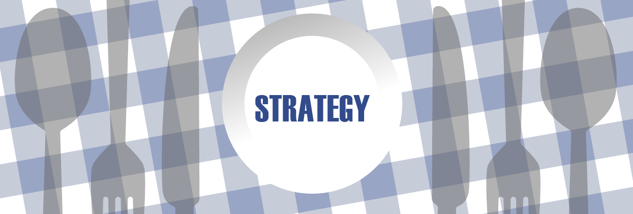 Overhead view of picnic table with the word Strategy written on a plate