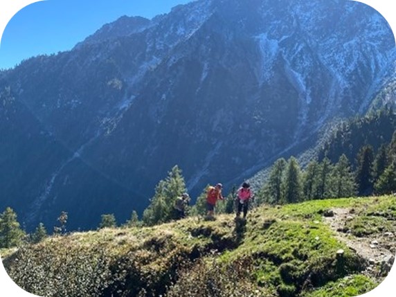 People hiking on a trail with a mountain