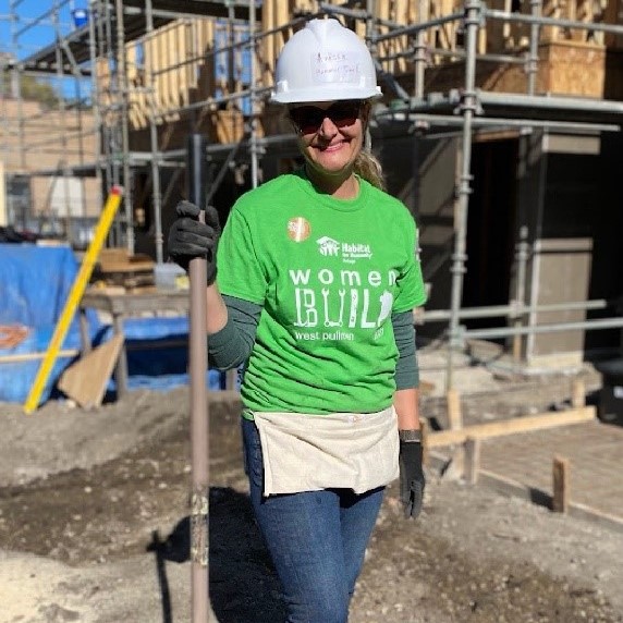 Woman holding tools at a construction site