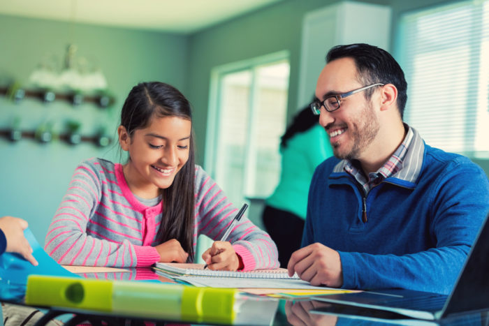 Dad helps pre-teen daughter with school assignment